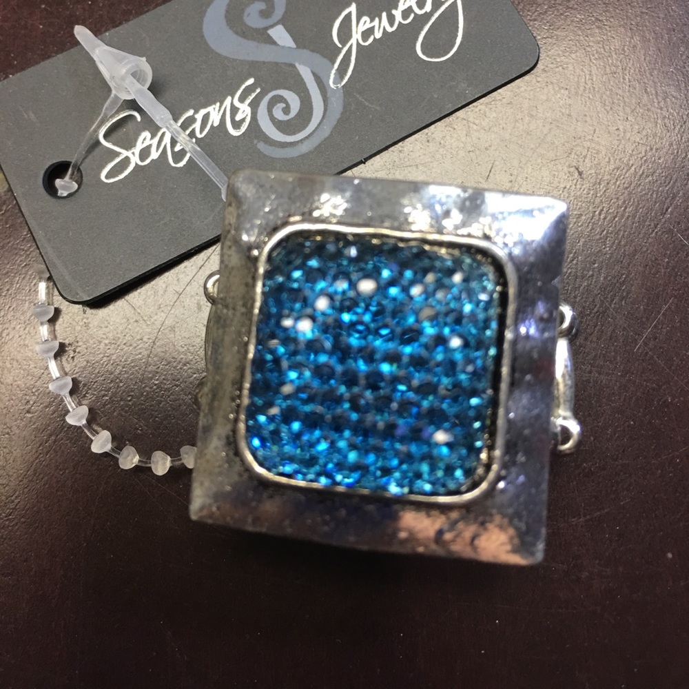 Ring Stretches to fit.  Square with Blue Center