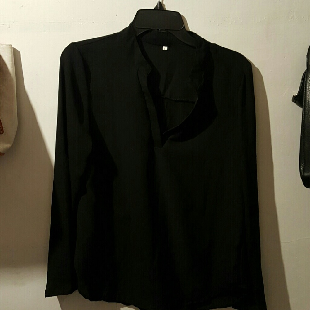 Long sleeve, sheer blouse with roll up sleeves.