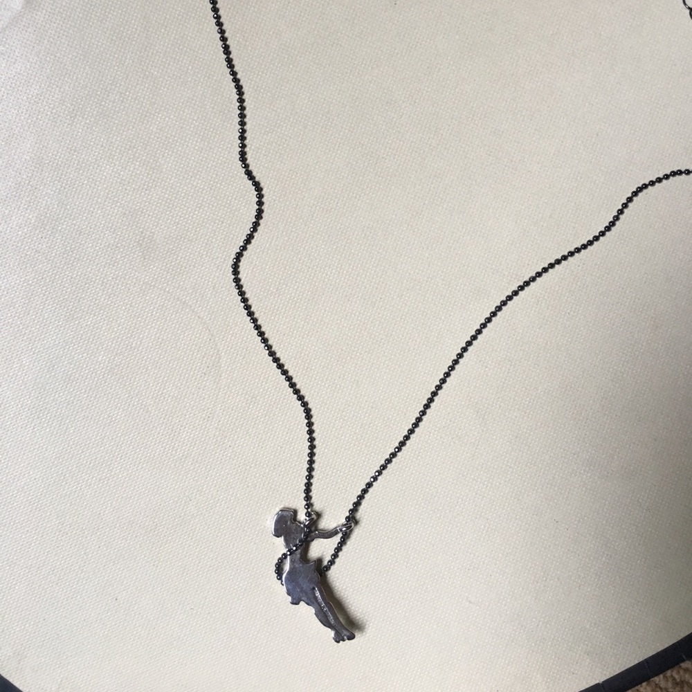 Girl swinging necklace