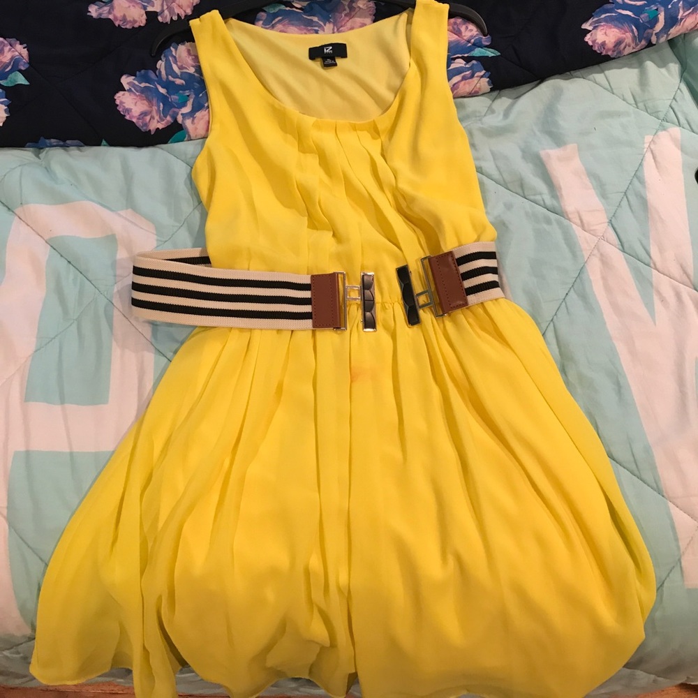 Yellow knee-high dress with a black and white belt