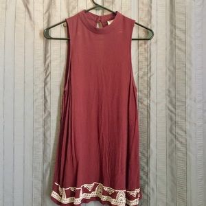 Maroon high neck top.