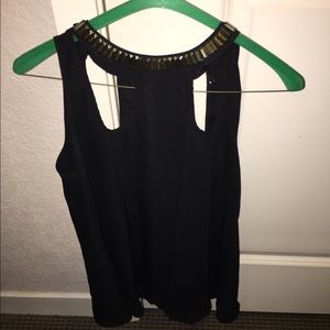 Black tank top with gold around the neck