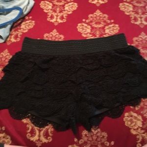 front and back view of black lace shorts
