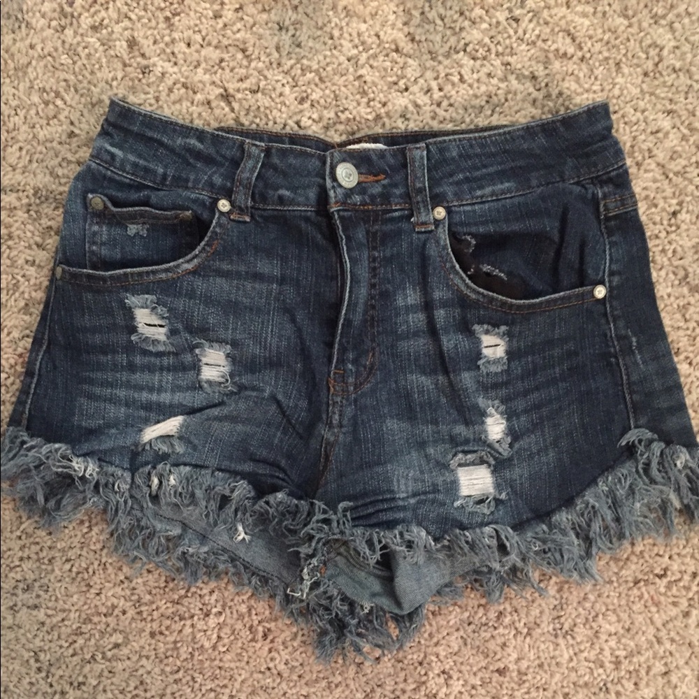 Distressed dark wash jean shorts with frayed hem