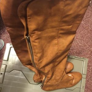 Tan knee high boots.