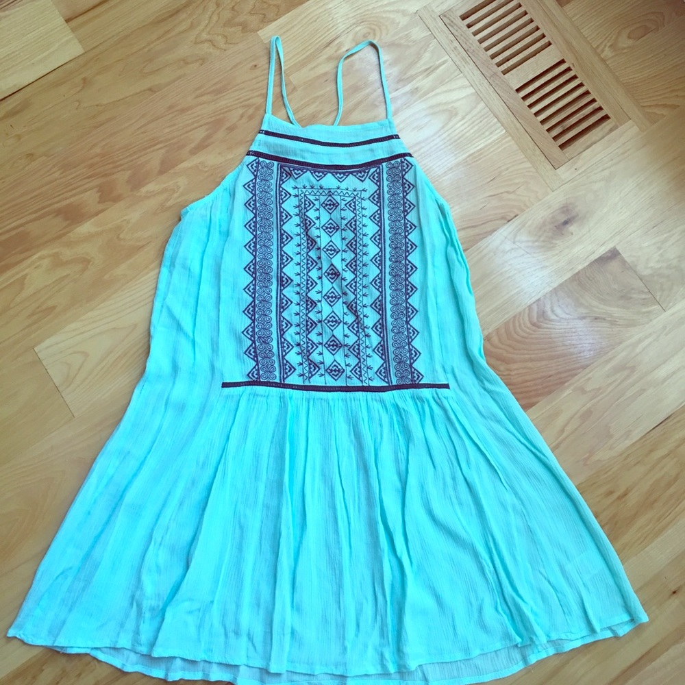 Turquoise sleeveless dress with navy detailing.