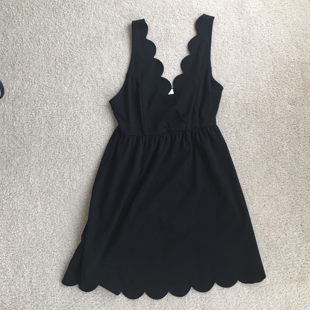 Little black dress with scalloped neckline and hem