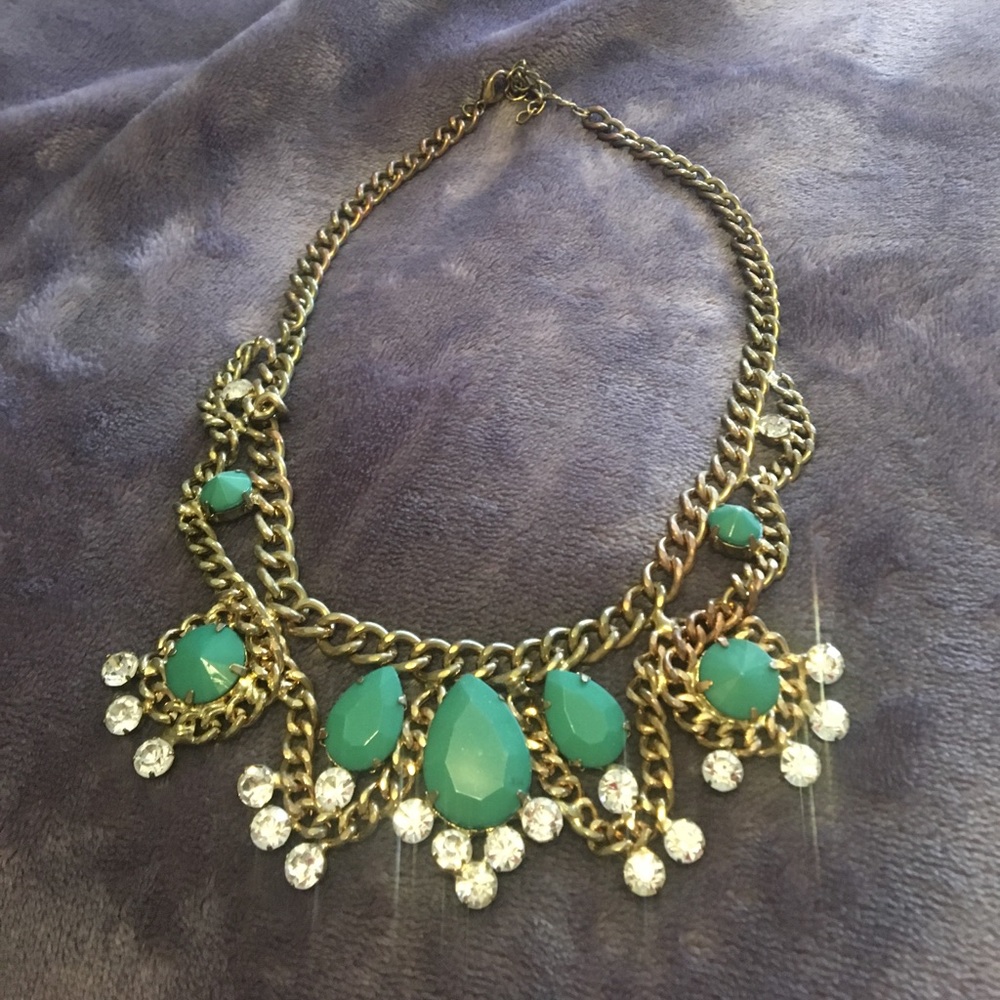 Worn a handful of times gold necklace with green