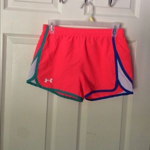 Pink,green and blue under armor running shorts.