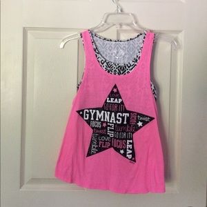 A pink tank top that has a built in sports bra.