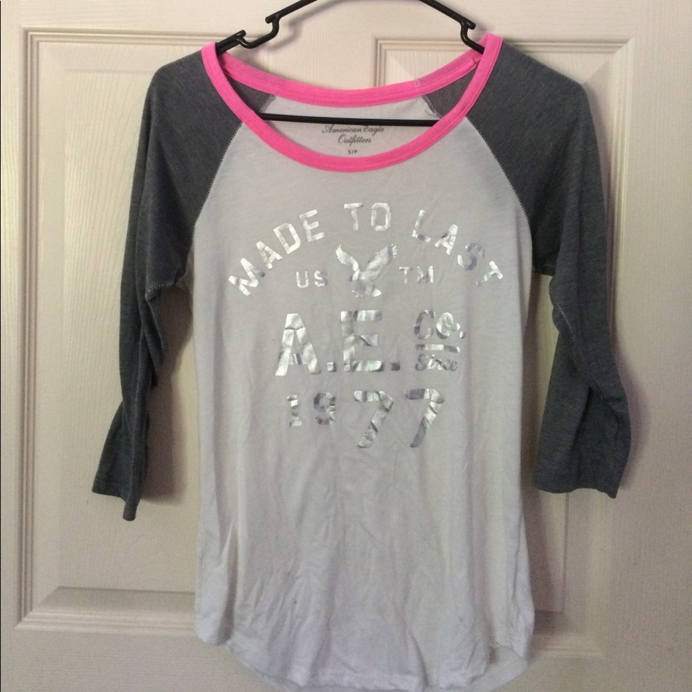 A white and gray half sleeve American eagle shirt.