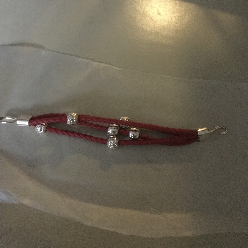 Red and silver tone beaded;braided bracelet.