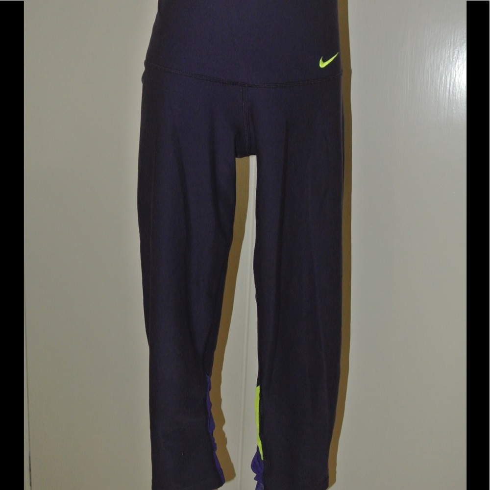 Purple Nike leggings with mesh panels on back legs