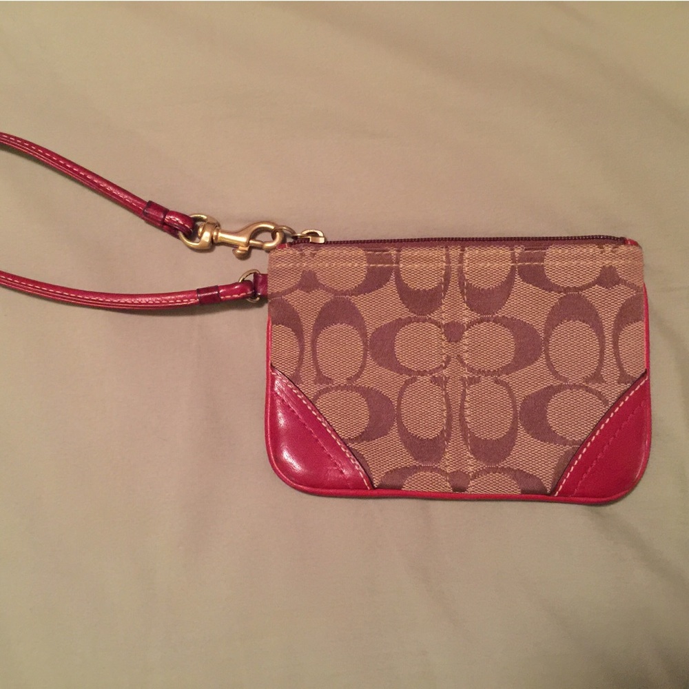 Coach wristlet with red leather accents.