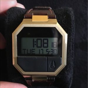 digital nixon with a brown leather band