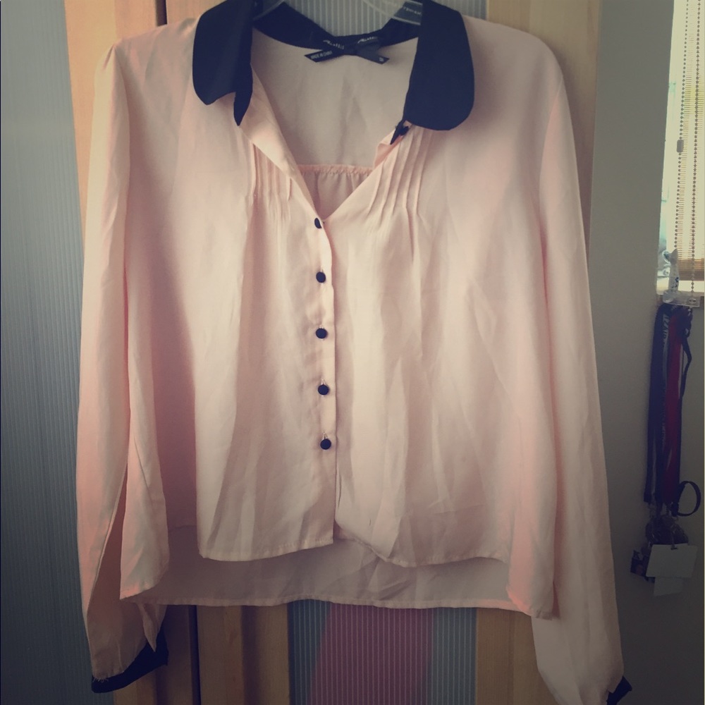 Pink blouse with black neck.