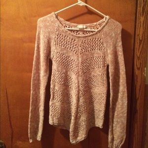 A peach and white sweater with a cute design.