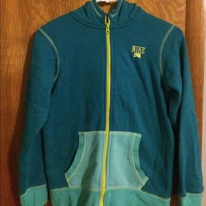 A blue, teal, and yellow zip up Nike jacket