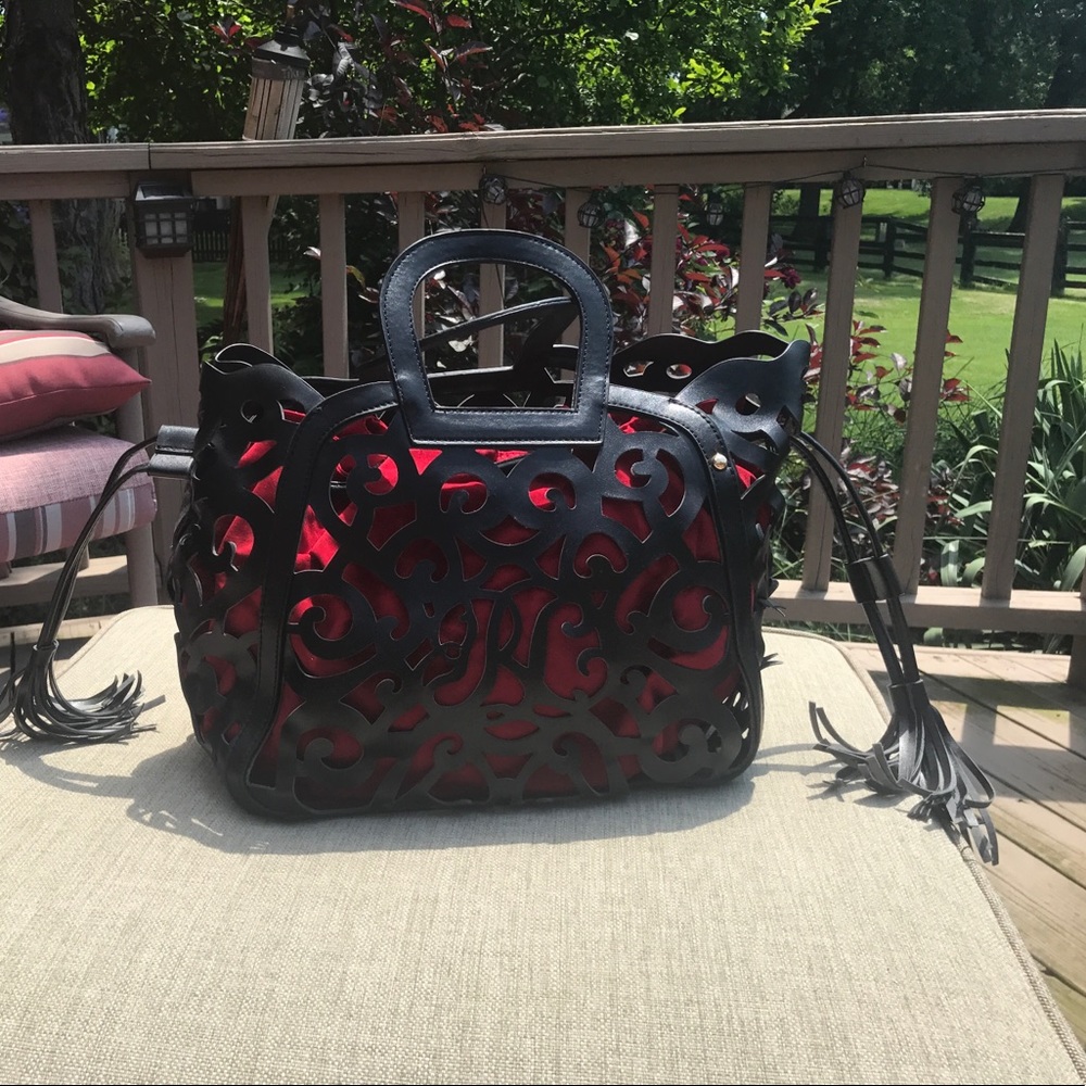 Unique scroll laser cut handbag