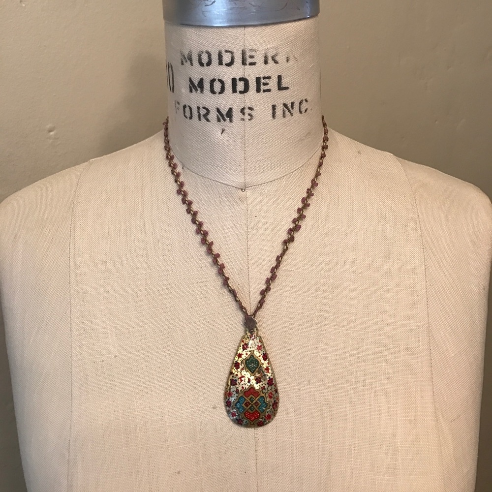 Necklace with painted shell pendant.