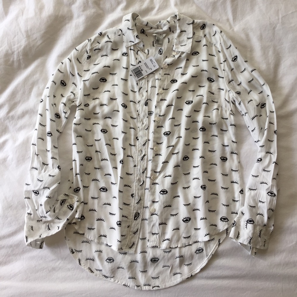 White long sleeve button up shirt with eye pattern