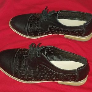 Women tie up saddle shoes