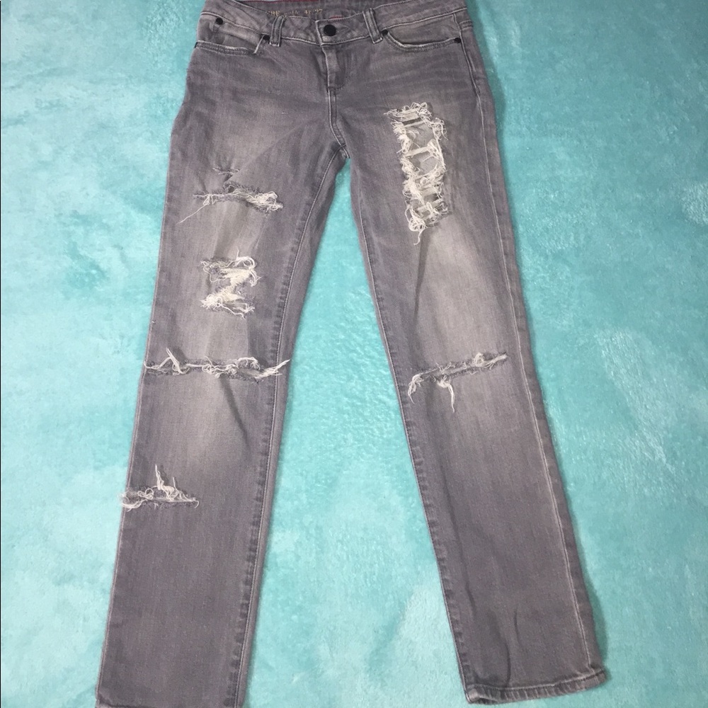 light gray, low waisted, ripped jeans.