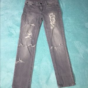 light gray, low waisted, ripped jeans.