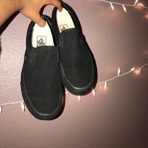 All black slip on vans