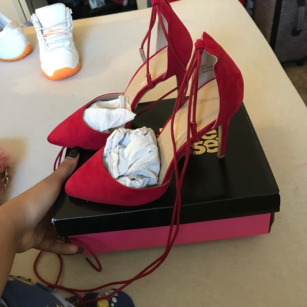 Red pointy lace-up pumps