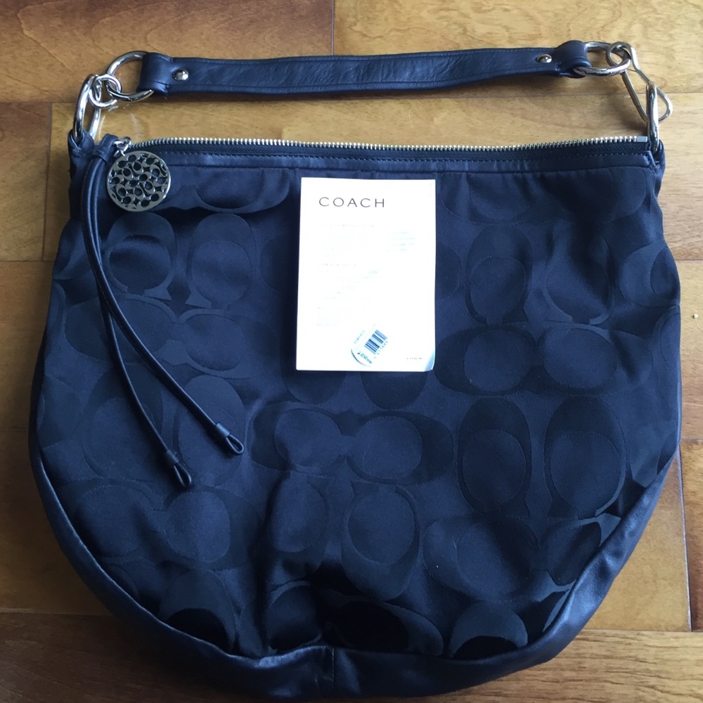 Coach Signature collection cloth handbag.