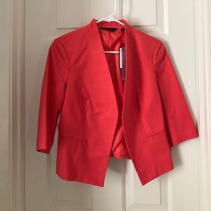 Salmon colored blazer.