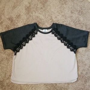 Light mauve top with grey sleeves.