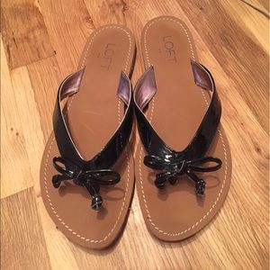 Black flip flops with decorative bow from the Loft