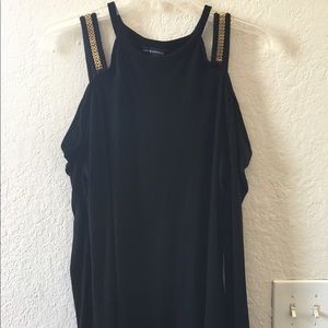 Black with gold shirt with cropped long sleeve.