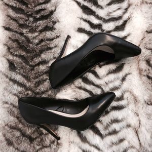 Black faux leather pumps