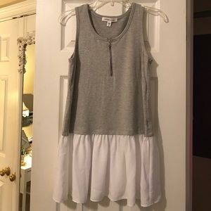 Sleeveless peplum tank with zipper detail.