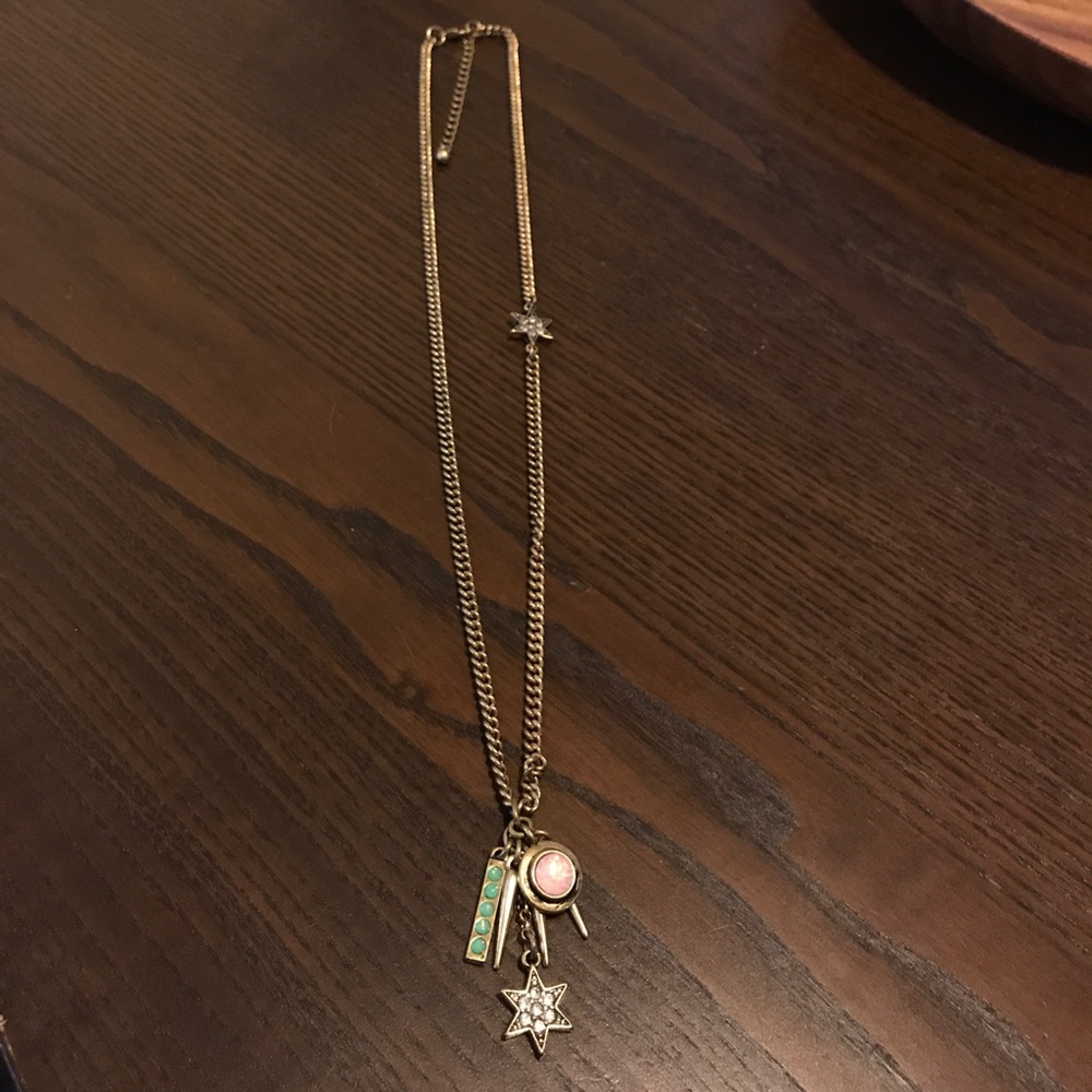 Long gold necklace with charms
