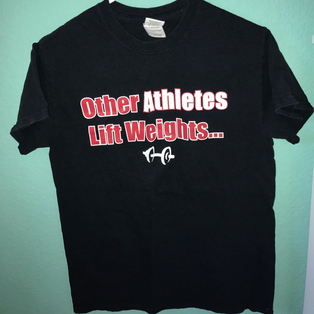 Cheerleaders lift athletes shirt