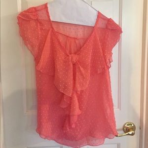 Bright peachy sheer top with texture dots.