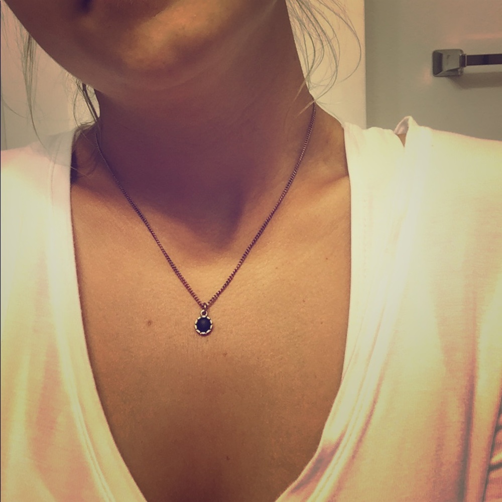 Gold necklace w/ blue stone.