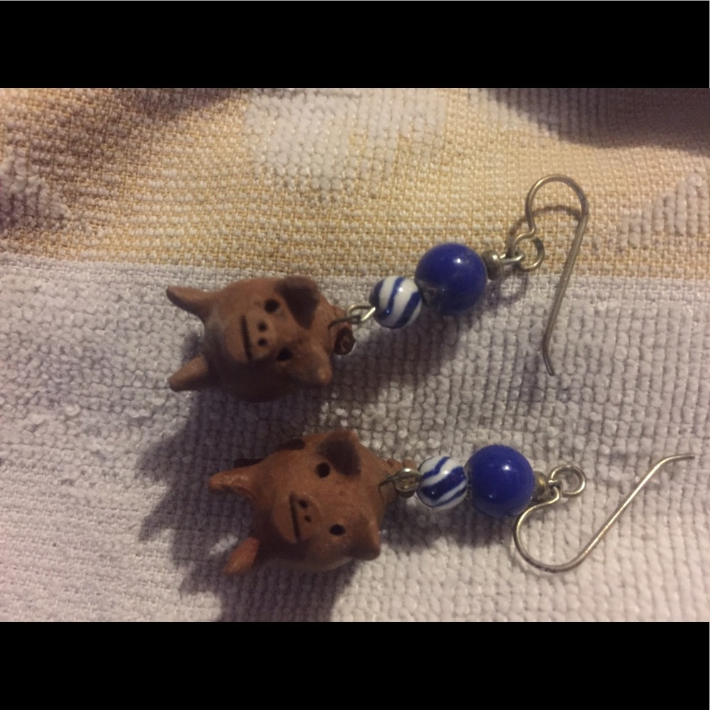 Little clay pigs with glass beads on steel hooks