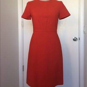 Chic orange-red dress with subtle detailing
