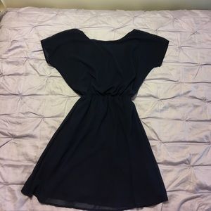 Navy dress with a white bow on the back.