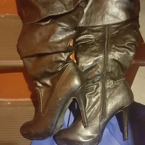 Thigh high black leather heeled boots