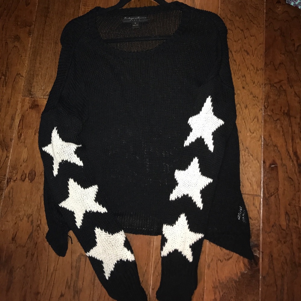 Black sweater with white stars down sleeve