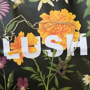 Light metal chain with multicolored rock pendant.