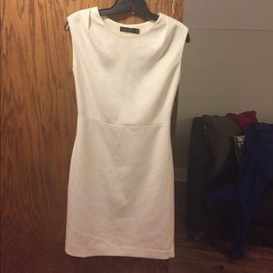 White sleeveless high neck dress.