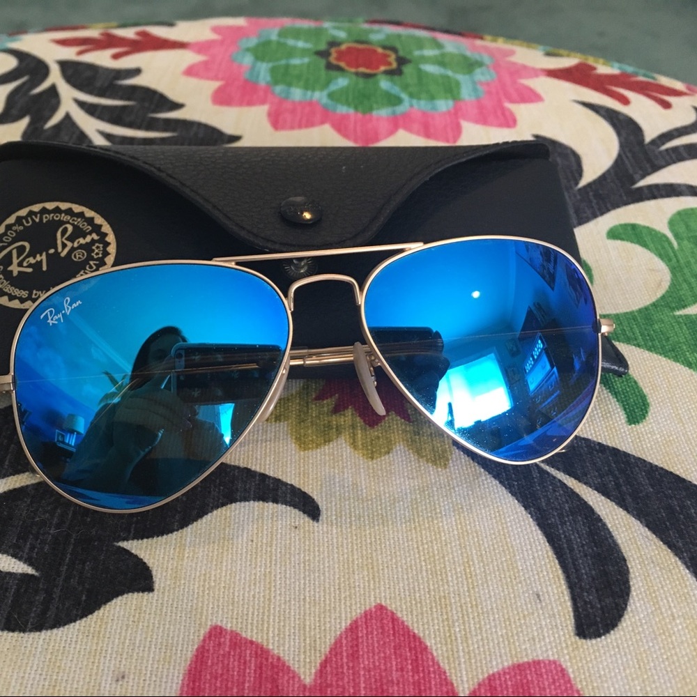 Ray-Ban mirrored blue aviators with gold rims.