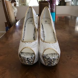 White lace and snake styled heels with gold spikes
